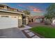 Close up of a charming two-story home featuring a well-maintained lawn and spacious three-car garage at 5919 S Banning St, Gilbert, AZ 85298