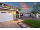 Inviting home exterior featuring a two-car garage, meticulously landscaped front yard, and a cozy entryway at 5919 S Banning St, Gilbert, AZ 85298
