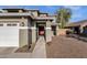 Inviting home exterior featuring a covered entryway, desert landscaping, and a two-car garage at 5919 S Banning St, Gilbert, AZ 85298