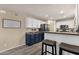 Kitchen with a breakfast bar, stainless appliances, white cabinets, and decorative accents at 5919 S Banning St, Gilbert, AZ 85298