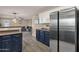 Bright, modern kitchen with stainless steel appliances and white and blue cabinets at 5919 S Banning St, Gilbert, AZ 85298