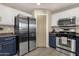 Kitchen featuring stainless steel appliances, pantry, and white and blue cabinets at 5919 S Banning St, Gilbert, AZ 85298