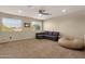 Spacious living room with neutral walls, a comfortable gray sofa and large windows at 5919 S Banning St, Gilbert, AZ 85298