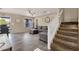 Open-concept living room featuring wood-look flooring, a ceiling fan, and staircase at 5919 S Banning St, Gilbert, AZ 85298