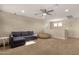 Bright living room with neutral walls, a comfortable gray sofa, and bright natural light at 5919 S Banning St, Gilbert, AZ 85298