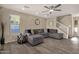 Spacious living room with modern finishes, wood-look flooring, and an inviting staircase to the upper level at 5919 S Banning St, Gilbert, AZ 85298