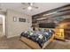 Stylish main bedroom featuring a wood accent wall, ceiling fan, and neutral color scheme at 5919 S Banning St, Gilbert, AZ 85298