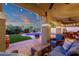 Inviting outdoor patio featuring stylish wicker furniture and a view of the sparkling pool at dusk at 5919 S Banning St, Gilbert, AZ 85298