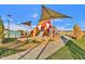 Modern playground with pyramid climbing structure, slides, and sun shades at 5919 S Banning St, Gilbert, AZ 85298