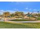 Large community playground with lush green grass, walking paths, and covered seating areas for residents at 5919 S Banning St, Gilbert, AZ 85298