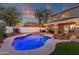 Stunning pool area with covered patio, lounge seating, and meticulous landscaping, perfect for outdoor entertaining at 5919 S Banning St, Gilbert, AZ 85298