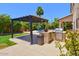 Covered patio, outdoor kitchen, and pool provide homeowners outdoor entertainment space at 6570 S Pewter Way, Chandler, AZ 85249
