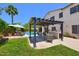 Backyard featuring a pool, covered pergola, outdoor kitchen and barbecue, and outdoor seating area at 6570 S Pewter Way, Chandler, AZ 85249