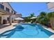 Beautiful backyard featuring a pristine pool, built-in BBQ, and lush landscaping for ultimate relaxation at 6570 S Pewter Way, Chandler, AZ 85249