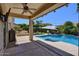 Covered patio next to a sparkling pool and built-in BBQ area, perfect for outdoor entertaining at 6570 S Pewter Way, Chandler, AZ 85249
