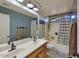 Well-lit bathroom featuring a dual sink vanity and a shower-tub combination with neutral color walls at 6570 S Pewter Way, Chandler, AZ 85249