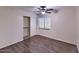 Bedroom with laminate floors, standard closet, a ceiling fan, and natural light from window at 6570 S Pewter Way, Chandler, AZ 85249