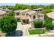 Well-manicured two-story home with lush front yard, mature trees, and a welcoming entrance at 6570 S Pewter Way, Chandler, AZ 85249