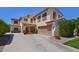 Two-story stucco home featuring a tile roof, arched windows, desert landscaping, and a two-car garage at 6570 S Pewter Way, Chandler, AZ 85249