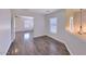 Spacious hallway features laminate flooring and a window, with the entry to the adjacent bedroom visible at 6570 S Pewter Way, Chandler, AZ 85249
