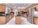 Well-lit kitchen featuring granite countertops, stainless steel appliances, and tile floors at 6570 S Pewter Way, Chandler, AZ 85249