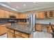 Modern kitchen with wood cabinets, granite countertops, stainless steel appliances and tile flooring at 6570 S Pewter Way, Chandler, AZ 85249