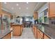 Bright kitchen with stainless steel appliances and granite countertops connected to a cozy living space at 6570 S Pewter Way, Chandler, AZ 85249