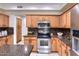 Kitchen featuring granite countertops, stainless steel appliances, and a center island at 6570 S Pewter Way, Chandler, AZ 85249