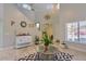 Inviting living room with tile floors, large windows, high ceilings, modern decor, and natural light at 6570 S Pewter Way, Chandler, AZ 85249