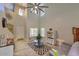 Open concept living room with two story ceilings, tile flooring, large ceiling fan, and modern furnishings at 6570 S Pewter Way, Chandler, AZ 85249