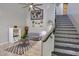 Bright living room with high ceilings, modern decor, tiled staircase, and large world map wall art at 6570 S Pewter Way, Chandler, AZ 85249