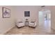 Cozy seating arrangement in a living area featuring tile floors and warm natural light at 6570 S Pewter Way, Chandler, AZ 85249