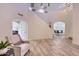 Spacious living room with tile floors, arched doorways, and easy access to the dining area at 6570 S Pewter Way, Chandler, AZ 85249