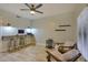 Bright home office features built-in desk space, floating shelves, a ceiling fan and comfortable seating at 6570 S Pewter Way, Chandler, AZ 85249