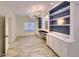 Home office features built-in shelving, cabinets, desk space, and stylish lighting fixtures at 6570 S Pewter Way, Chandler, AZ 85249