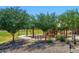 Community playground featuring mature shade trees, play equipment and walking paths at 6570 S Pewter Way, Chandler, AZ 85249