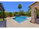 Private backyard features a sparkling blue pool, a pergola, and lush tropical landscaping at 6570 S Pewter Way, Chandler, AZ 85249