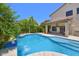 The backyard features a refreshing pool and covered patio, perfect for entertaining at 6570 S Pewter Way, Chandler, AZ 85249
