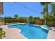 Private backyard features a sparkling blue pool, a pergola, and lush tropical landscaping at 6570 S Pewter Way, Chandler, AZ 85249