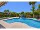 Private backyard features a sparkling blue pool, a pergola, and lush tropical landscaping at 6570 S Pewter Way, Chandler, AZ 85249