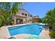 Backyard featuring a sparkling pool, covered patio, and lush landscaping, ideal for outdoor enjoyment at 6570 S Pewter Way, Chandler, AZ 85249