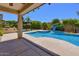 Pool and covered patio make for a great outdoor space in this home's backyard at 6570 S Pewter Way, Chandler, AZ 85249
