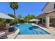 A backyard pool featuring a calming waterfall feature and desert landscaping at 6570 S Pewter Way, Chandler, AZ 85249