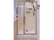 Stand-up shower featuring frameless shower doors, shower caddy, and updated shower head at 6570 S Pewter Way, Chandler, AZ 85249