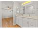 Bathroom featuring double sinks, quartz countertops, and a view into a bedroom at 6843 S 46Th Dr, Laveen, AZ 85339