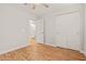 Bright bedroom with wood flooring, ceiling fan, and sliding closet at 6843 S 46Th Dr, Laveen, AZ 85339
