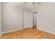 A bedroom featuring a closet, wood-look floors, and access to another room at 6843 S 46Th Dr, Laveen, AZ 85339