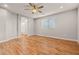 A bedroom with a ceiling fan, wood-look floors, and a window at 6843 S 46Th Dr, Laveen, AZ 85339