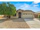 Charming single-story home with a well-maintained yard and a two-car garage with beautiful desert landscaping at 6843 S 46Th Dr, Laveen, AZ 85339