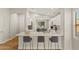 Bright, open kitchen with a breakfast bar, white cabinets, and modern appliances at 6843 S 46Th Dr, Laveen, AZ 85339